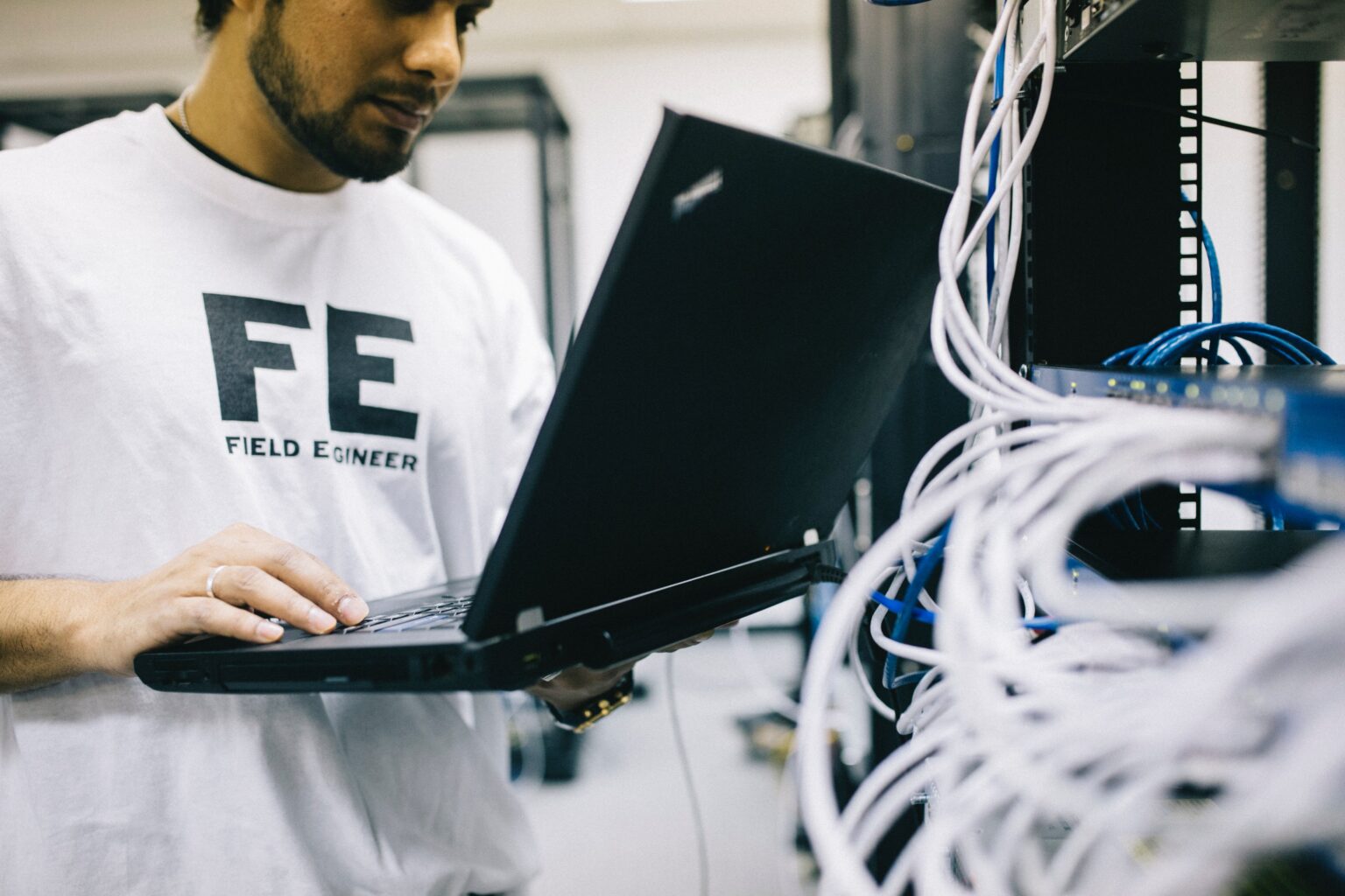 A man using a laptop to evaluate a server