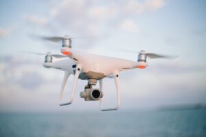 A camera drone flying over the sea with a blurred background