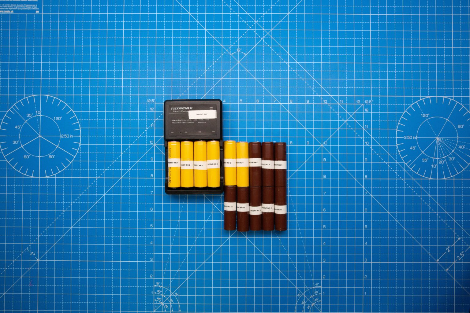 An18650 Battery Charger on top of blue measurement paper