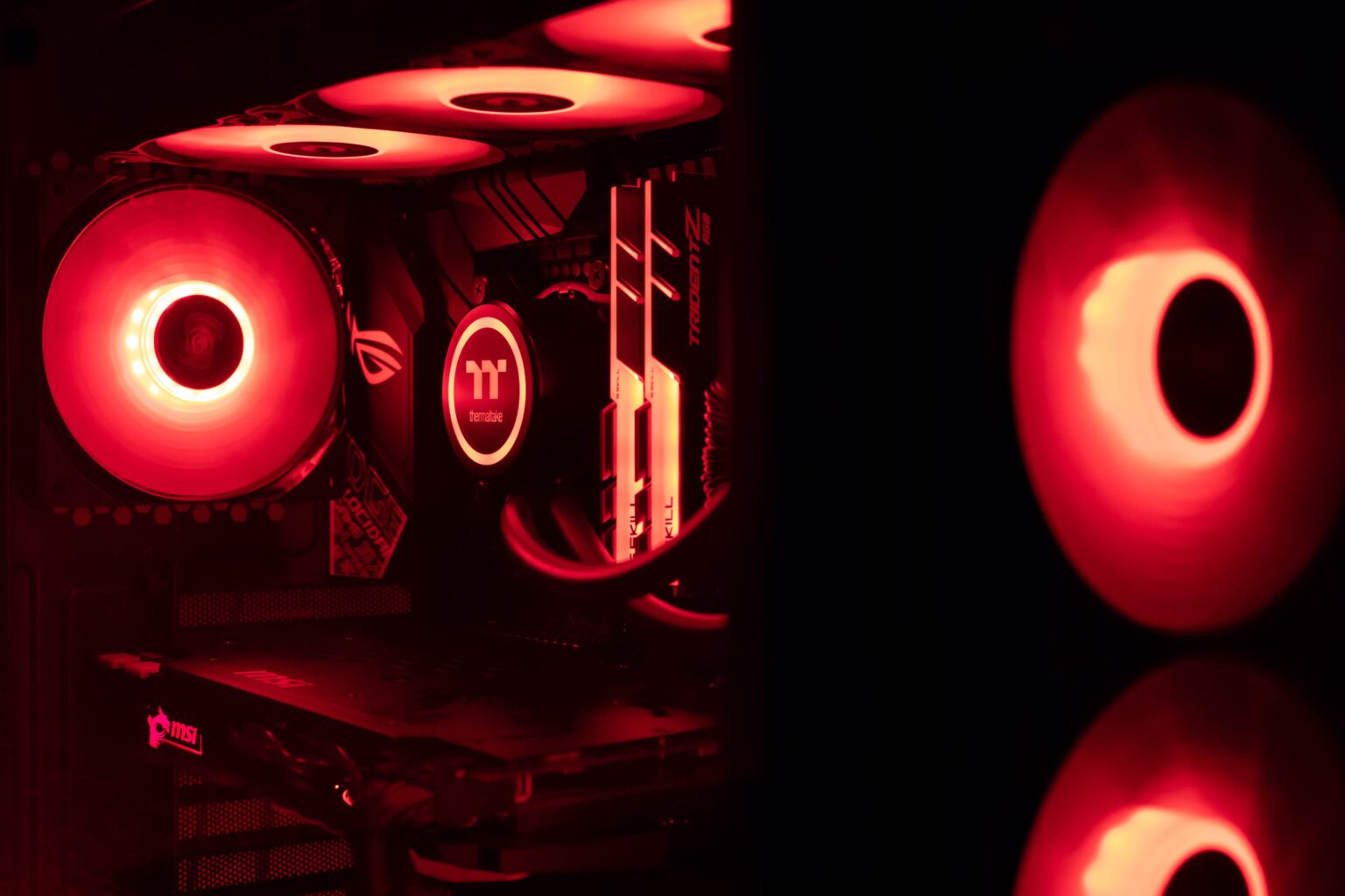 A closeup of the inside of a PC with red LED fans