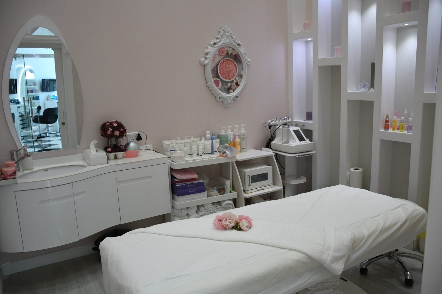 A small beauty saloon room with a massage table in it