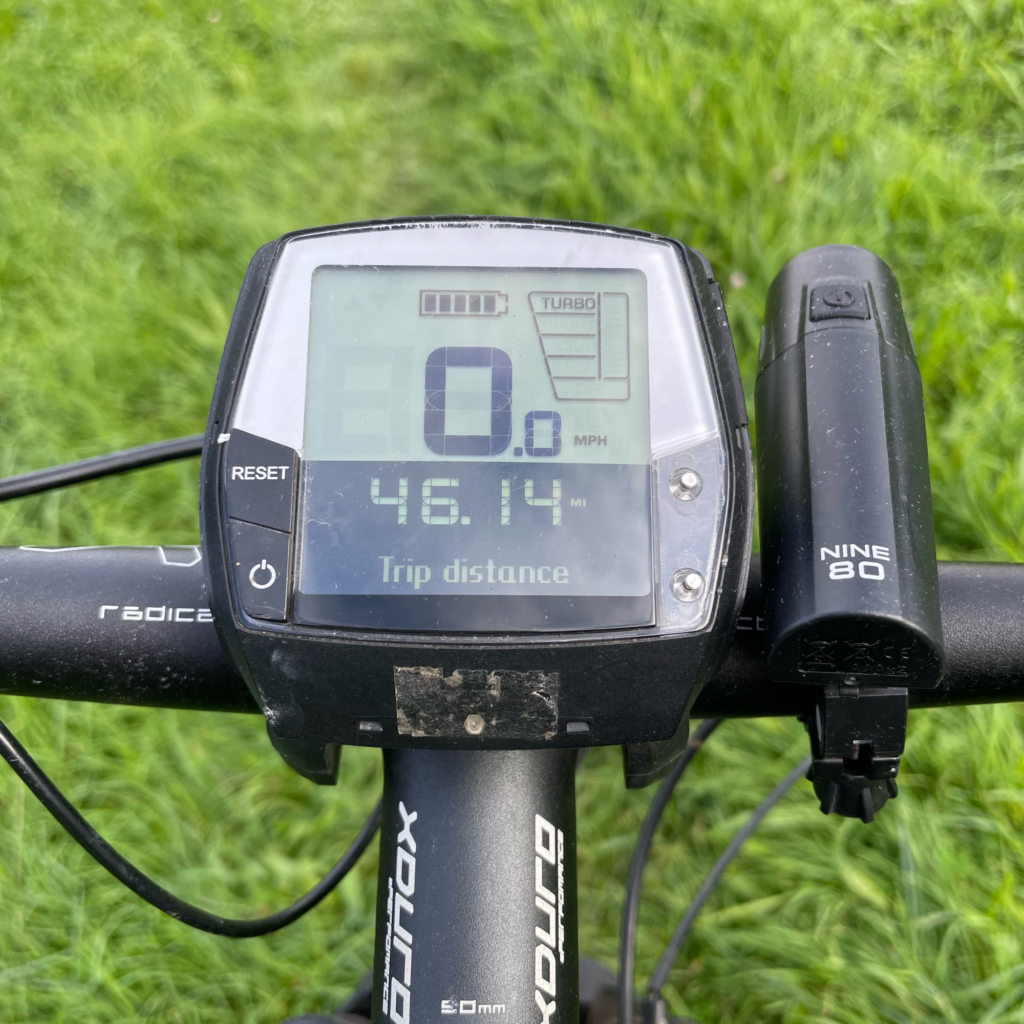 A closeup of the Bosch Intuvia Multifunctional Display with grass behind it