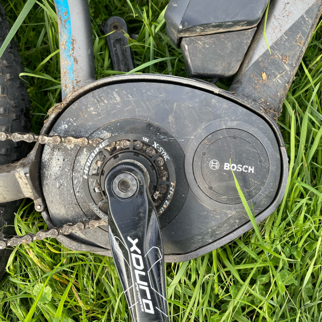 A closeup of the Bosch Midmount Performance Motor with grass in the background