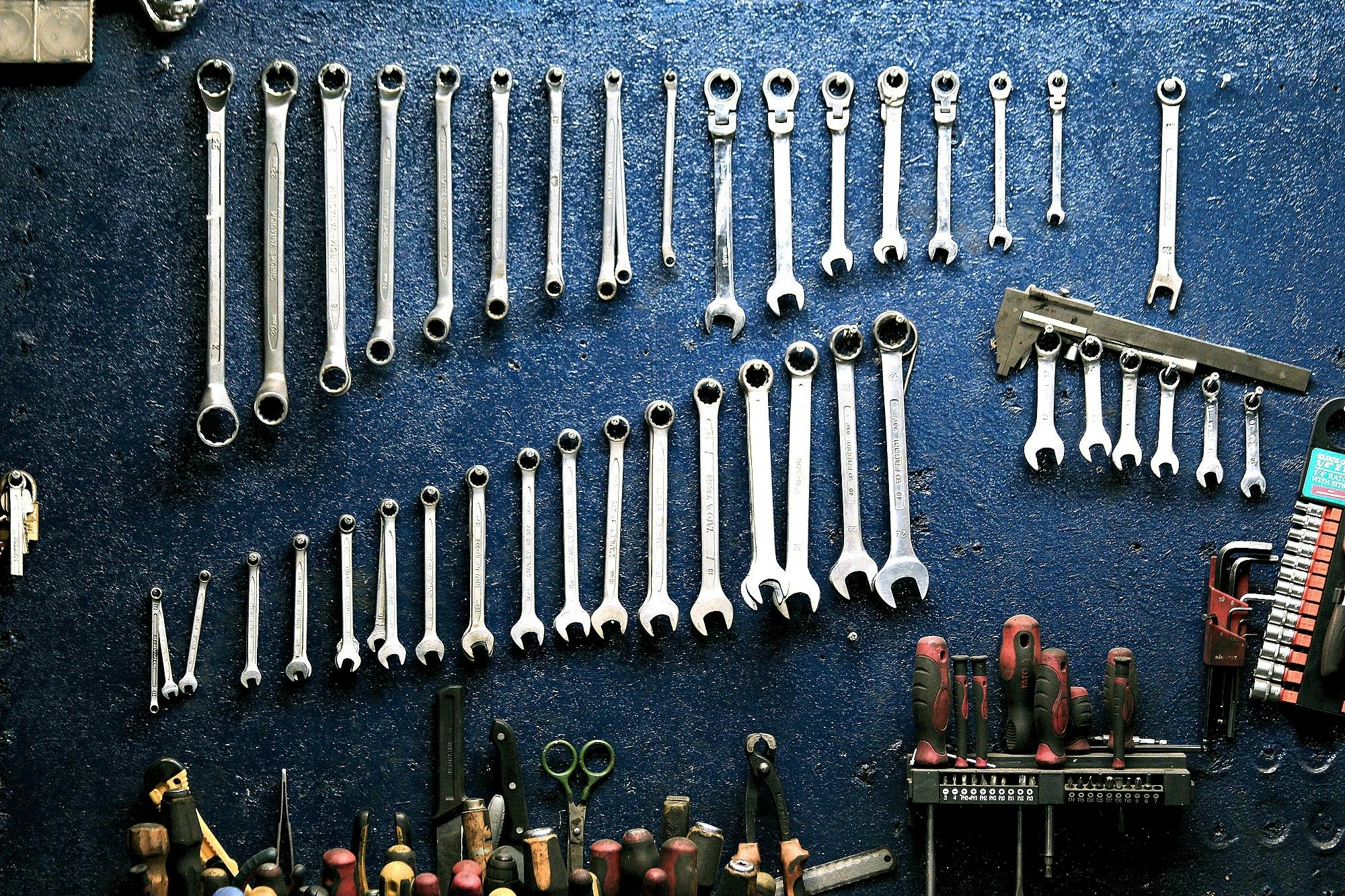 Spanners of different sizes on a workshop wall